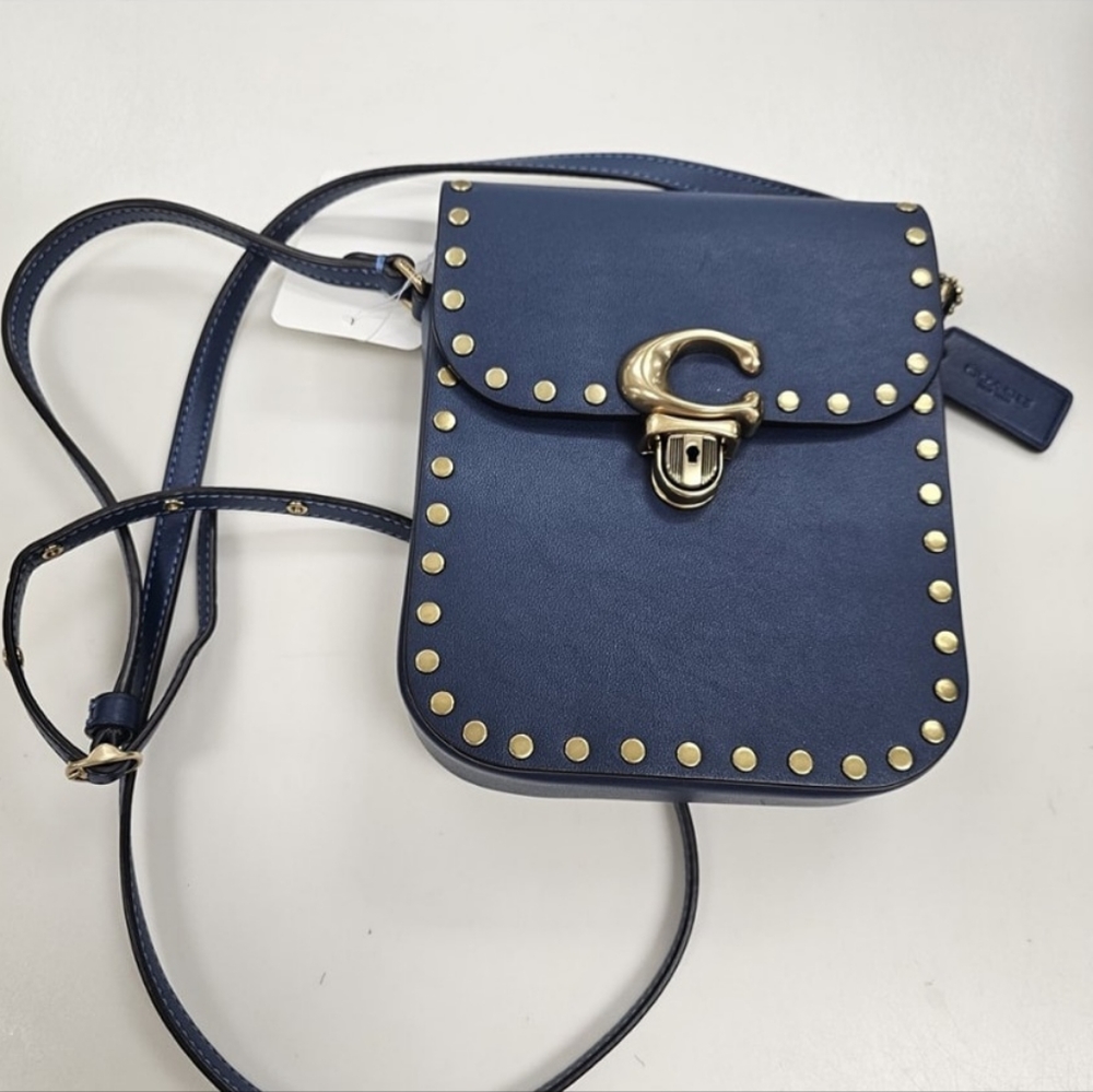 Coach Tall Studio crossbody with rivets in blue.